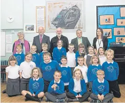  ??  ?? Members of Stonehaven Heritage Society with head teacher Melanie Fowler and some of the pupils of Catterline Primary.