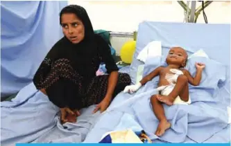 ??  ?? KUTUPALONG, Bangladesh: Myanmar refugee Halima with her eight-month-old son Muhammed Hares are treated at the Red Cross clinic in Kutupalong refugee camp in Ukhia. — AFP