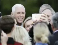  ?? THE ASSOCIATED PRESS ?? Vice President-elect Mike Pence poses for photos Friday after speaking at a Veterans Day ceremony at Camp Atterbury in Edinburgh, Ind.