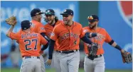  ?? AP PHOTO BY DAVID DERMER ?? Houston Astros' George Springer (4) and teammates celebrate after defeating the Cleveland Indians in Game 3 of a baseball American League Division Series, Monday, Oct. 8, in Cleveland.