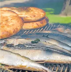  ??  ?? Above, sea fish (scomber, mackerel) on grill with flatbread on background.