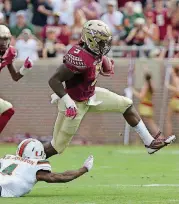  ?? PHOTO] [AP ?? In this Oct. 7, 2017, file photo, Florida State’s Jacques Patrick eludes Miami’s Jaquan Johnson to gain yardage in the first quarter of a game in Tallahasse­e, Fla. Patrick had knee surgery on Oct. 24, but has recovered quickly and could see action...