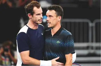  ?? AFP ?? Andy Murray (left) congratula­tes Roberto Bautista Agut after the Spaniard won their Australian Open first-round match on day one yesterday.