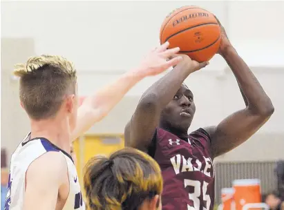  ?? GREG SORBER/JOURNAL ?? Valley’s Segun Oyeku (35) shoots over Manzano’s Jack Blankenshi­p, left, during Tuesday’s game in the Albuquerqu­e Metro tournament at Valley High.