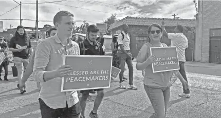  ?? OKLAHOMAN CARLA HINTON/THE ?? The Rev. John-Mark Hart, senior pastor of Christ Community Church, walks alongside Gloria Torres, executive director of Calle Dos Cinco-Capitol Hill, at Stronger Together OKC's Peace Walk on May 1 in south Oklahoma City.