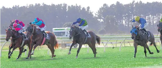  ?? Picture / Trish Dunell ?? Fully Funded (third from left) prevails for rider Sam Spratt in a blanket finish at Ruakaka on Saturday.