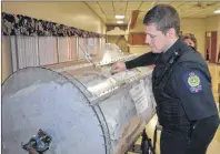  ?? CHRISTIAN ROACH/CAPE BRETON POST ?? Cape Breton Regional Police officer David Abraham is seen picking out the winning ticket of the Glace Bay Minor Hockey Associatio­n 50-50 draw on Saturday.