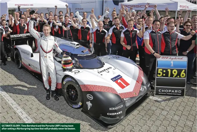  ??  ?? ULTIMATE GLORY. Timo Bernhard and the Porsche LMP1 racing team after setting a Nürburgrin­g lap time that will probably never be beaten.