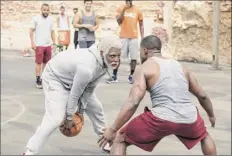  ?? Quantrell D. Colbert / Lionsgate via AP ?? Boston Celtics basketball player Kyrie Irving, left, portrays Uncle Drew in a scene from the comedy “Uncle Drew.”