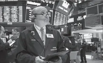 ?? -AP ?? Trader works on the floor of New York Stock Exchange.
