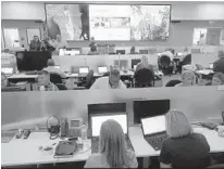  ?? JOE CAVARETTA/SOUTH FLORIDA SUN SENTINEL ?? Florida Power & Light Co. directs hurricane preparatio­n from its command center in Riviera Beach, shown during a simulation in May.