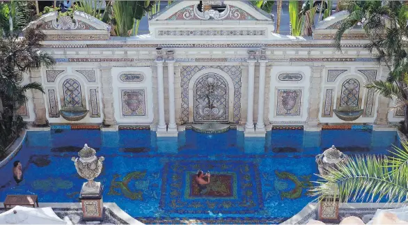  ?? PHOTOS: JENNIFER KAY/THE ASSOCIATED PRESS ?? Tourists lounge in the 24-karat-gold-tiled pool at The Villa Casa Casuarina, which was the former home of fashion designer Gianni Versace.