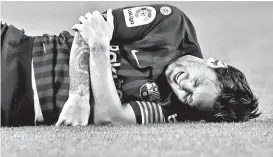  ?? AP PHOTO/MANU FERNANDEZ ?? IN PAIN. FC Barcelona’s Lionel Messi looks painfully injured during the Spanish La Liga soccer match between FC Barcelona and Sevilla at the Camp Nou stadium in Barcelona, Spain, Saturday, Oct. 20, 2018.