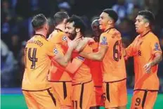  ?? AP ?? Liverpool’s Mohammad Salah (3rd left) celebrates after scoring his side’s second goal against FC Porto.