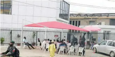  ??  ?? Customers of Zenith Bank, by first gate, Agidingbi seating outside and waiting to be ushered into the banking hall in compliance with crowd management.