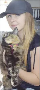  ?? SalTWire neTWOrk ?? Elysse Green is pictured with one of her cats. Her family has had two cats go missing in the last month, a trend noted by other pet owners in Westville.