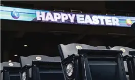  ?? GETTY IMAGES ?? Scoreboard­s around Kauffman Stadium display Easter wishes Sunday. The scheduled game between the White Sox and Royals was postponed.