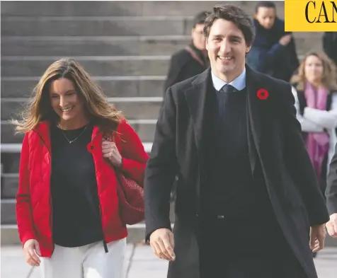  ?? ADRIAN WYLD / THE CANADIAN PRESS ?? Prime Minister Justin Trudeau walks with Liberal Party president Suzanne Cowan to a Liberal caucus meeting in Ottawa, Thursday.