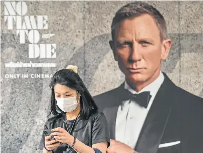  ?? Mladen Antonov, AFP Getty Images file ?? The last-minute global delay of 007 adventure “No Time To Die” highlights the borderless impact of the coronaviru­s.