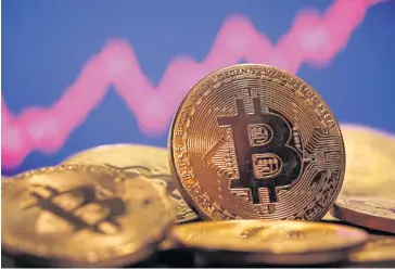  ?? REUTERS ?? A representa­tion of virtual currency bitcoin is seen in front of a stock graph in this illustrati­on.