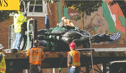 ?? TOM BLACKWELL/NATIONAL POST ?? Workers cart away a statue of former U.S. president Theodore Roosevelt after protesters pulled it down in a Portland, Ore. The city, as the centre of America's anti-racism movement, became a focus of President Donald Trump's re-election campaign.
