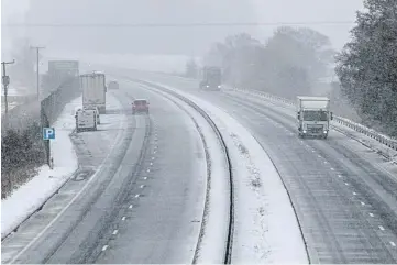  ??  ?? Tricky driving conditions on the A90 near Forfar, while the snow brought cheer to Robyn Downie, 13 and Emma Carnegie, 13, in Dundee. Pictures by Kim Cessford/Mhairi Edwards.