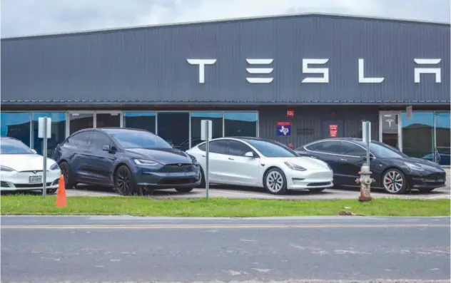  ?? ?? ↑ Tesla vehicles sit on the lot at a Tesla dealership in Austin, Texas.