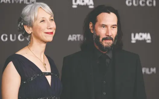  ?? FRAZER HARRISON/GETTY IMAGES ?? Alexandra Grant, left, and her steel-grey hair made quite the impression when the artist walked the red carpet with her beau, Keanu Reeves, in 2019.