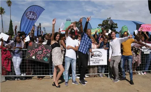  ??  ?? AUDITIONS: Idols host Proverb poses with hopefuls at the Joburg leg of of the competitio­n at the Carnival City.