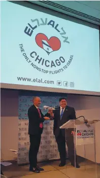  ??  ?? RIGHT: EL AL CEO Gonen Usishkin presents to Illinois Governor J.B. Pritzker a model of the 787 Dreamliner that will fly between Chicago and Tel Aviv.