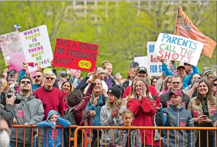  ?? SEAN D. ELLIOT/THE DAY ?? People opposed to a bill to repeal the state’s religious exemption for childhood vaccines rally Tuesday at the state Capitol.