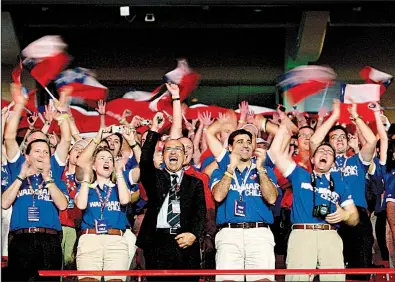  ?? Arkansas Democrat-Gazette file photo ?? Walmart employees from Chile cheer from their seats in Bud Walton Arena during the 2009 Walmart shareholde­rs meeting in Fayettevil­le. Analysts will watch during the week for any clues Walmart may give about its direction in the year ahead.