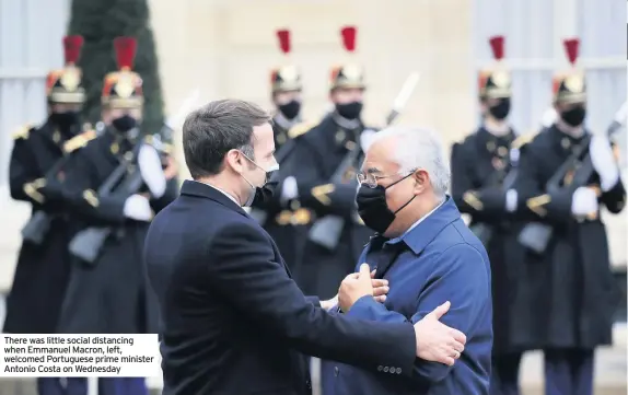  ??  ?? There was little social distancing when Emmanuel Macron, left, welcomed Portuguese prime minister Antonio Costa on Wednesday