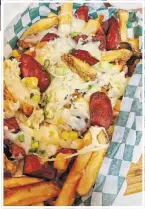  ??  ?? Salchipapa­s combines slices of chicken sausages and fries with sweet plantains, shredded mozzarella and corn kernels.