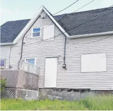  ??  ?? Half of a boarded up company house at 57 Church St. in Dominion is currently on the Cape Breton Regional Municipali­ty property tax sale with $4,095.86 owing.