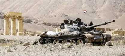 ??  ?? PALMYRA, Syria: Photo shows a Syrian army T-62 tank at the damaged site of the ancient city of Palmyra in central Syria. Syrian troops backed by Russian jets have completed the recapture of the historic city of Palmyra from Islamic State (IS) group...