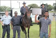  ?? PICTURE: TERRY HAYWOOD ?? MY LAPTOP: Queensburg­h resident Preston Mohanlall shows his computer which was retrieved hours after a robbery at his home. Behind him at the Westville North mobile CCTV command and control centre are Inspector Timothy Will, Constable Donovan Govender,...