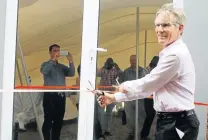  ?? Picture: BHONGO JACOB ?? NEW BEGINNINGS: Cargo Carriers CEO Murray Bolton cuts the ribbon at the entrance of the new Ezethu Logistics satellite deport in Queendustr­ia last week