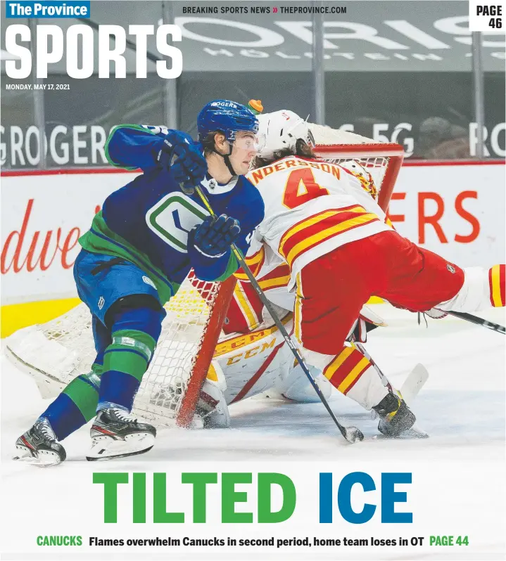  ?? BOB FRID/USA TODAY SPORTS ?? Calgary Flames goalie Jacob Markstrom looks on as Canucks' Nils Hoglander checks Rasmus Andersson in the first period at Rogers Arena Sunday.