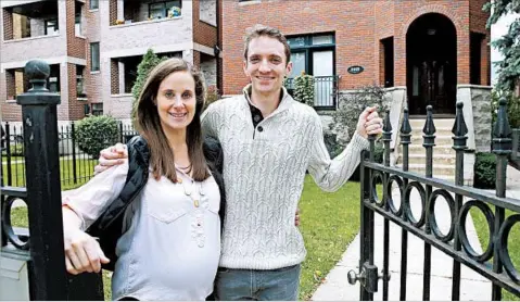  ?? CHARLES REX ARBOGAST/AP ?? Emily and Brian Townsend own the top-floor unit in a three-flat building in Chicago. They used gift money to help purchase the home.