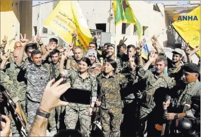  ??  ?? The Associated Press In this frame grab from video released Tuesday and provided by Hawar News Agency, fighters from the U.s.-backed Syrian Democratic Forces celebrate their victory in Raqqa, Syria.