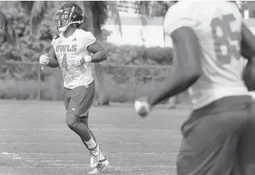  ?? CARLINE JEAN/SOUTH FLORIDA SUN SENTINEL ?? FAU running back BJ Emmons runs through drills at practice. Emmons is the leading contender to be a starter.