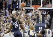  ?? ALEX BRANDON — THE ASSOCIATED PRESS ?? Villanova forward Dhamir Cosby-Roundtree (21) blocks a shot from Georgetown guard Jonathan Mulmore during the first half of Wednesday’s game in Washington.