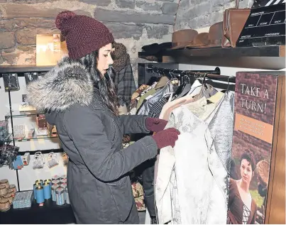  ?? Picture: David McNie. ?? Katie Gater picks out one of the period-style Outlander dresses available to the public wanting to emulate their screen favourites at Doune Castle.