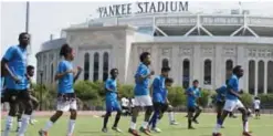  ??  ?? NEW YORK: Against a backdrop of Yankee Stadium players for South Bronx United go through their warm-ups before a match at Macombs Dam Park in New York. South Bronx United is composed of minors from Central America who arrived alone to the United...