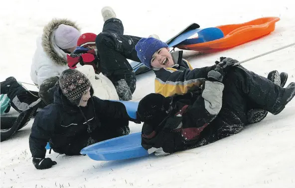  ??  ?? When children take part in simple activities like tobogganin­g, they are learning basic skills like how to fall without injury and react instantly to an ever-changing situation. Those skills will help them succeed in sports later in life. — CRAIG...