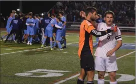  ?? AUSTIN HERTZOG MEDIANEWS GROUP ?? As North Penn celebrates in the background, Boyertown goalkeeper Mason Kurtz and defender Ryan Foskey, right, shake hands after the District 1 final.