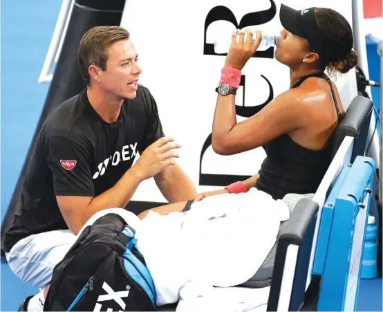  ??  ?? Naomi Osaka talks to her coach Sascha Bajin, left, during her semifinal match against Lesia Tsurenko Photo: AP