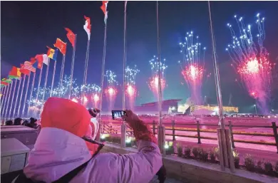  ?? MARK HOFFMAN / MILWAUKEE JOURNAL SENTINEL ?? Fireworks illuminate the sky during the opening ceremony for the Pyeongchan­g 2018 Olympic Winter Games at the Olympic Stadium. More photos at jsonline.com/sports.