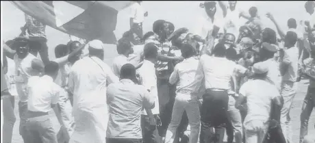  ?? ?? Fans storm Kensington Oval to celebrate Hedges West Indies Cricket Annual) the West Indies two-wicket victory (Source 1988 Benson &